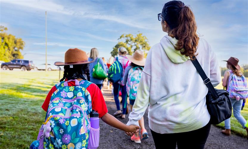 Students wearing western wear walk to school